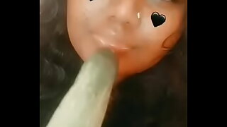 some ugly indian girl sucking a cucumber